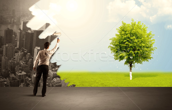 Salesman painting tree instead of city Stock photo © ra2studio