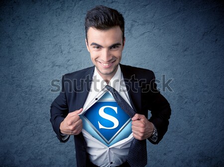 Stock photo: Businessman ripping off his shirt with superhero sign 