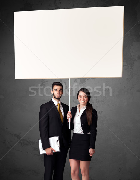 Business couple with blank whiteboard Stock photo © ra2studio