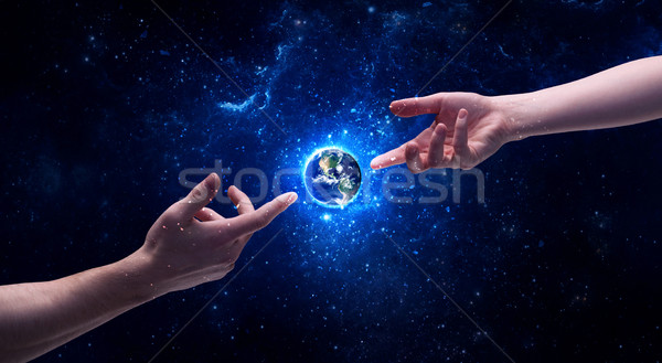 Hands in space touching planet earth Stock photo © ra2studio