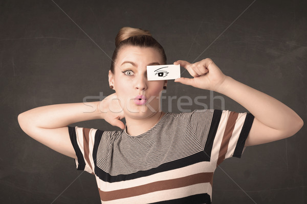 Stock photo: Silly youngster looking with hand drawn eye paper