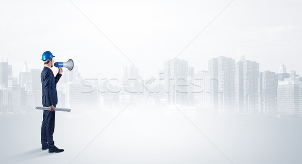 Architect standing and  looking at a big city panorama Stock photo © ra2studio