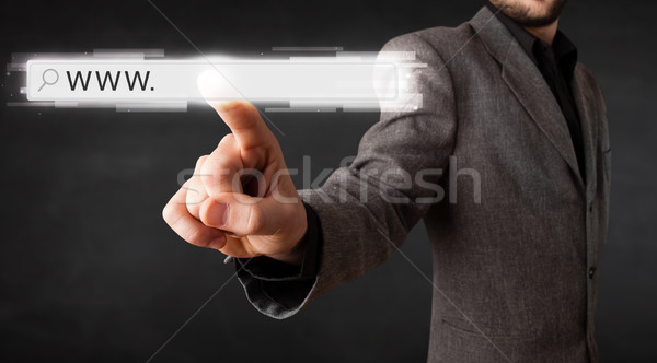 Young businessman touching web browser address bar with www sign Stock photo © ra2studio