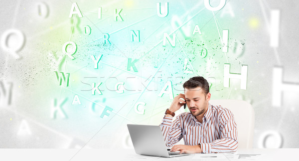 Business man at desk with green word cloud Stock photo © ra2studio