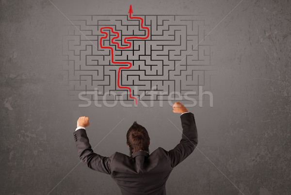 Stock photo: Business man looking at a maze and the way out 