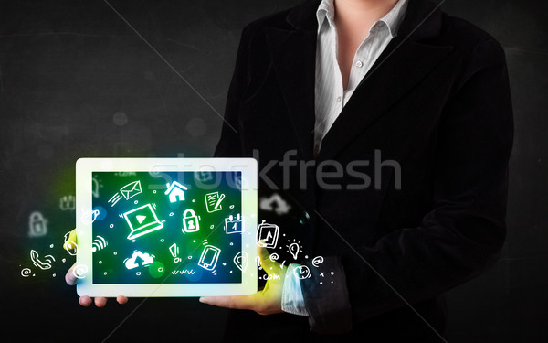 Person holding tablet with green media icons and symbols Stock photo © ra2studio