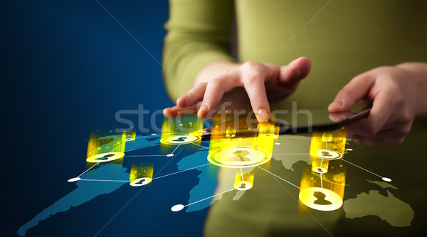 Hand holding tablet device with social network map Stock photo © ra2studio