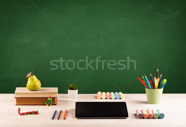 School items on desk with empty chalkboard Stock photo © ra2studio