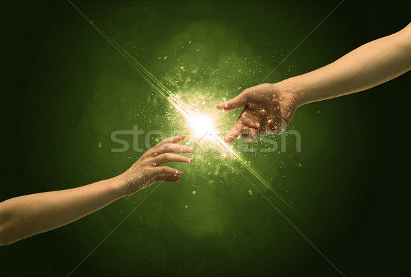 Touching arms lighting spark at fingertip Stock photo © ra2studio