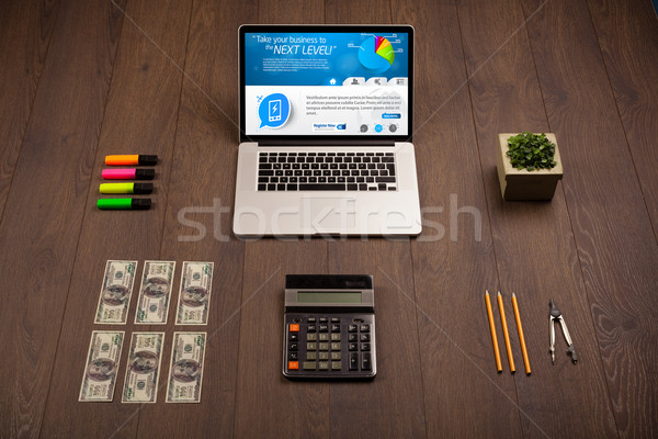 Laptop on office desk with business website on screen Stock photo © ra2studio