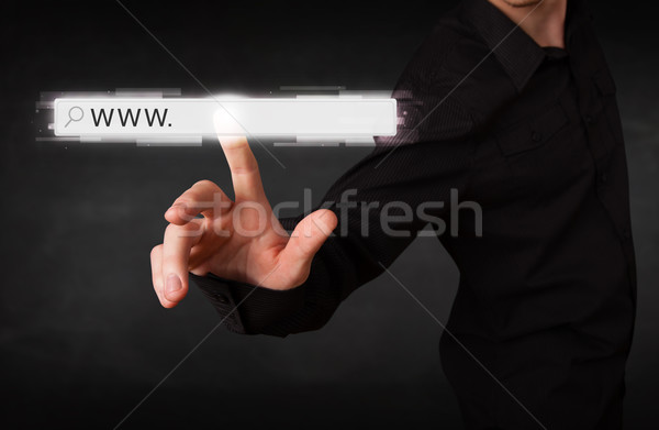 Young businessman touching web browser address bar with www sign Stock photo © ra2studio