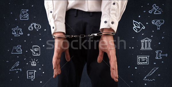 Symbols of courthouse with handcuffed man Stock photo © ra2studio