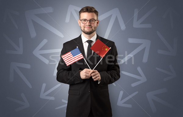Cheerful boy standing with flag and arrows around Stock photo © ra2studio