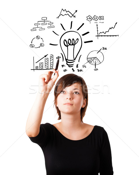 Stock photo: Young business woman drawing light bulb with various diagrams on whiteboard isolated on white