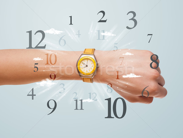 Hand with watch and numbers on the side comming out Stock photo © ra2studio