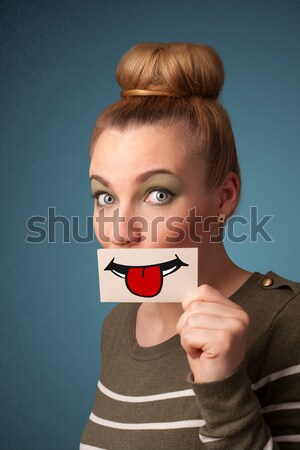 Happy pretty woman holding card with funny smiley Stock photo © ra2studio