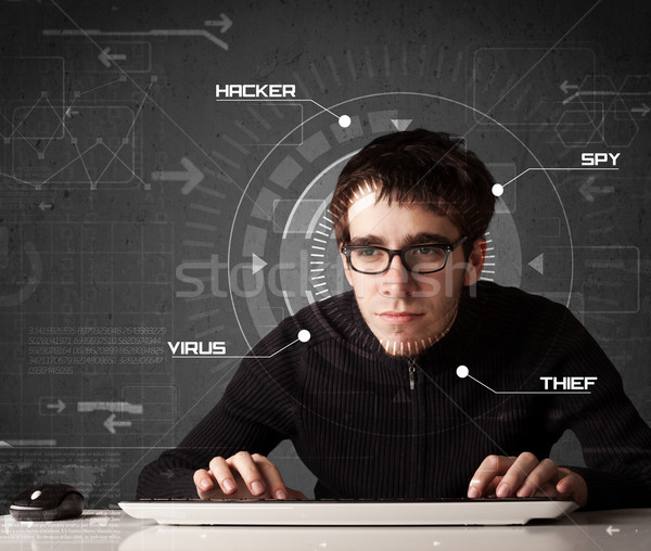 Young hacker in futuristic enviroment hacking personal informati Stock photo © ra2studio