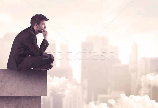 Peaceful sales guy sitting on roof top Stock photo © ra2studio