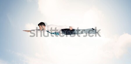 Business man flying like a superhero in clouds on the sky Stock photo © ra2studio