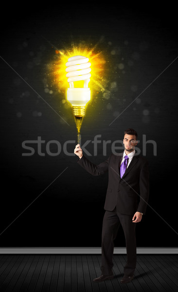 Businessman with an eco-friendly bulb Stock photo © ra2studio