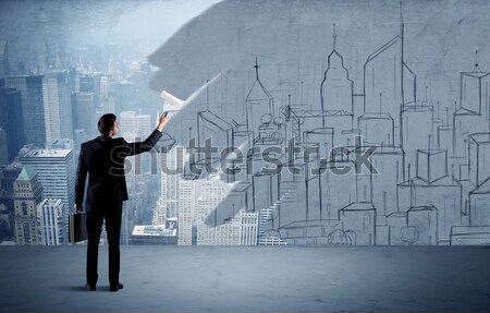 Elegant salesman repainting the city on wall Stock photo © ra2studio