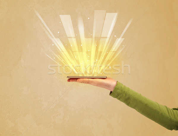 Hand with telephone and yellow light Stock photo © ra2studio