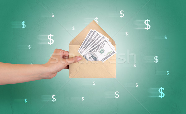 Hand holding envelope with symbols around Stock photo © ra2studio