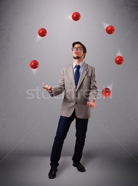 Młody człowiek stałego żonglerka czerwony przystojny Zdjęcia stock © ra2studio