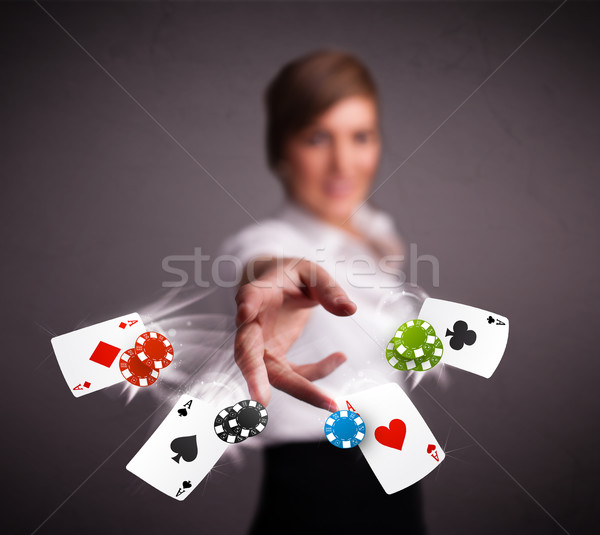 Stock photo: Young woman playing with poker cards and chips 