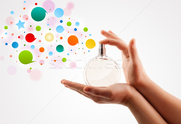 close up of woman hands spraying colorful bubbles from beautiful perfume bottle Stock photo © ra2studio