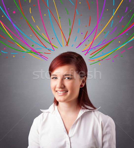 Young girl thinking with colorful abstract lines overhead Stock photo © ra2studio