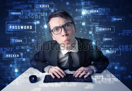 Stock photo: Hacker programing in technology enviroment with cyber icons 