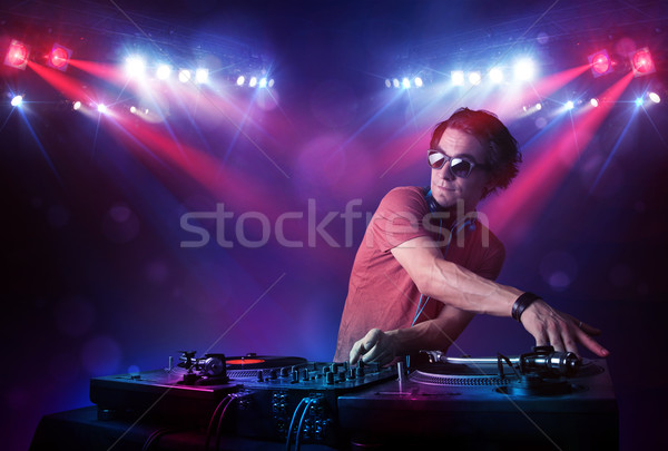 Teenager dj mixing records in front of a crowd on stage Stock photo © ra2studio