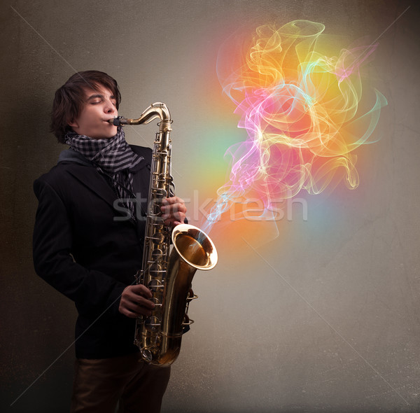 Attractive musician playing on saxophone with colorful abstract  Stock photo © ra2studio