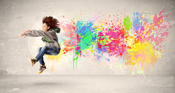 Felice adolescente jumping colorato inchiostro splatter Foto d'archivio © ra2studio