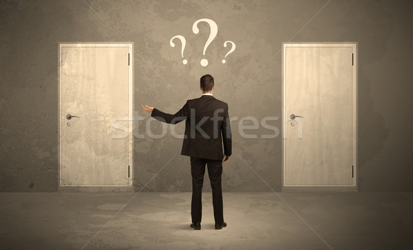 Businessman standing in front of doors Stock photo © ra2studio