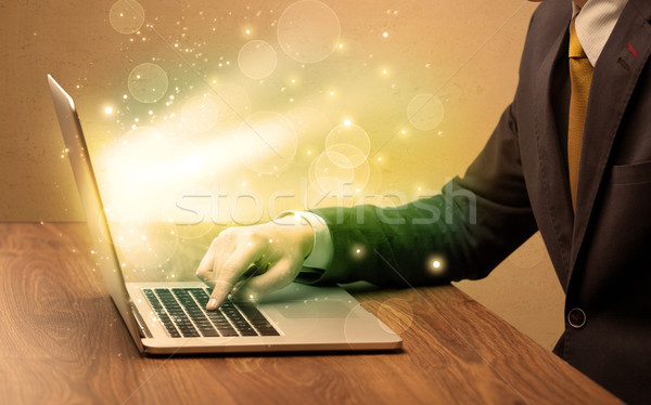 Businessman working fast on laptop Stock photo © ra2studio