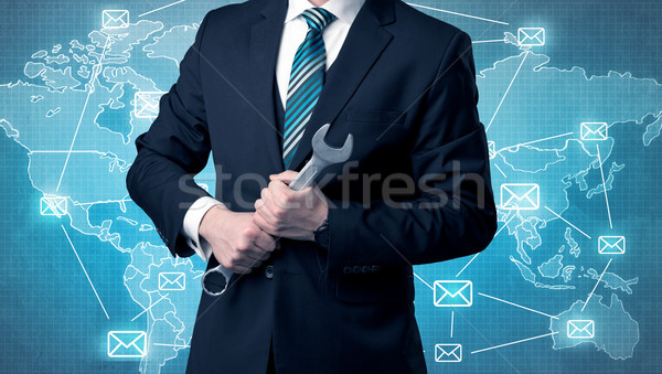 Stock photo: Handsome businassman standing with tool on his hand