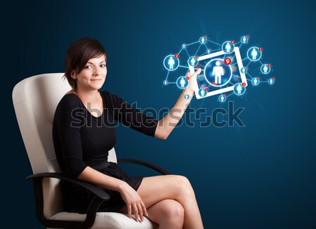 young woman holding tablet with social network icons Stock photo © ra2studio