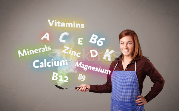 Young woman cooking vitamins and minerals Stock photo © ra2studio