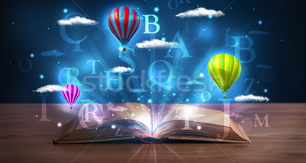 Open book with glowing fantasy abstract clouds and balloons Stock photo © ra2studio