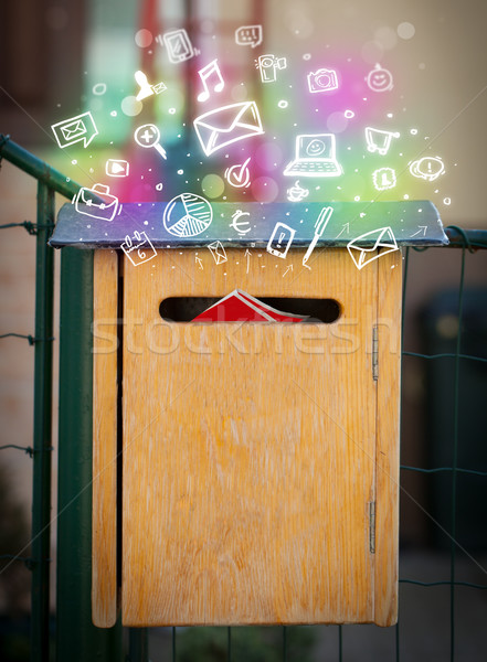Colorful icons and symbols bursting out of a mailbox Stock photo © ra2studio