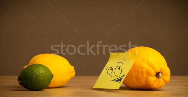 Lemon with post-it note looking curiously at citrus fruits Stock photo © ra2studio