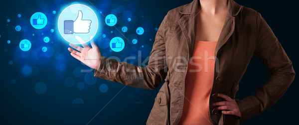 Young businesswoman pressing thumbs up button on modern social n Stock photo © ra2studio