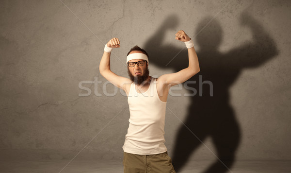 Skinny man with musculous shadow Stock photo © ra2studio