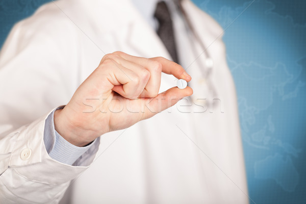 Doctor in white holding a pill Stock photo © ra2studio