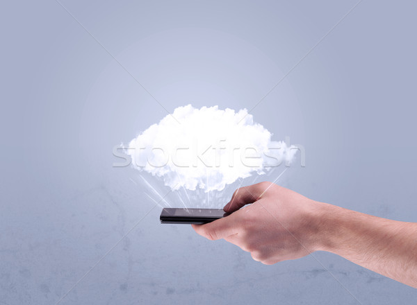 Hand holding phone with empty cloud Stock photo © ra2studio