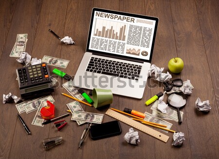 Computer desk with laptop and red arrow chart in screen Stock photo © ra2studio