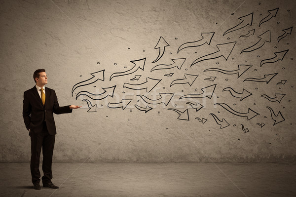Business man holding arrow signs Stock photo © ra2studio