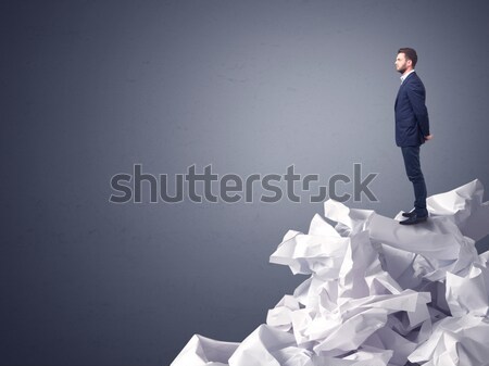 Businessman standing on crumpled paper Stock photo © ra2studio
